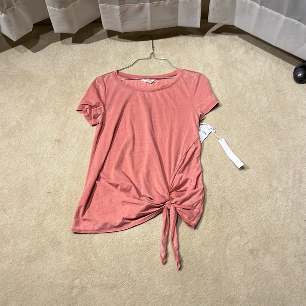 pink shirt with a tie on right side